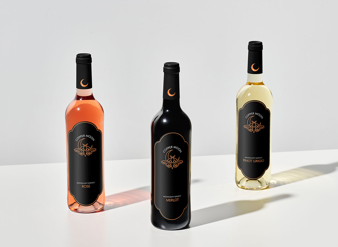 Three wine bottles with new coppermoon packaging