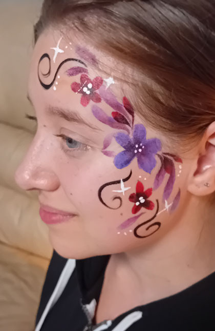 Photo of woman with Purple and Red flower facepaint