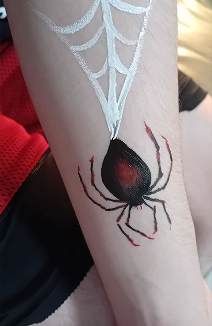 Photo of arm with painted spider and web