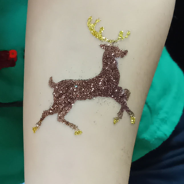 Photo of brown and gold deer glitter tattoo