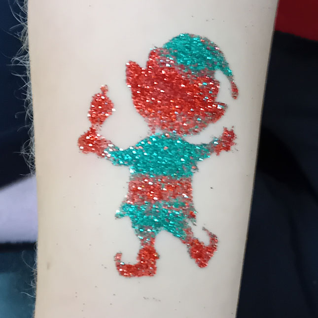 Photo of red and green christmas elf glitter tattoo